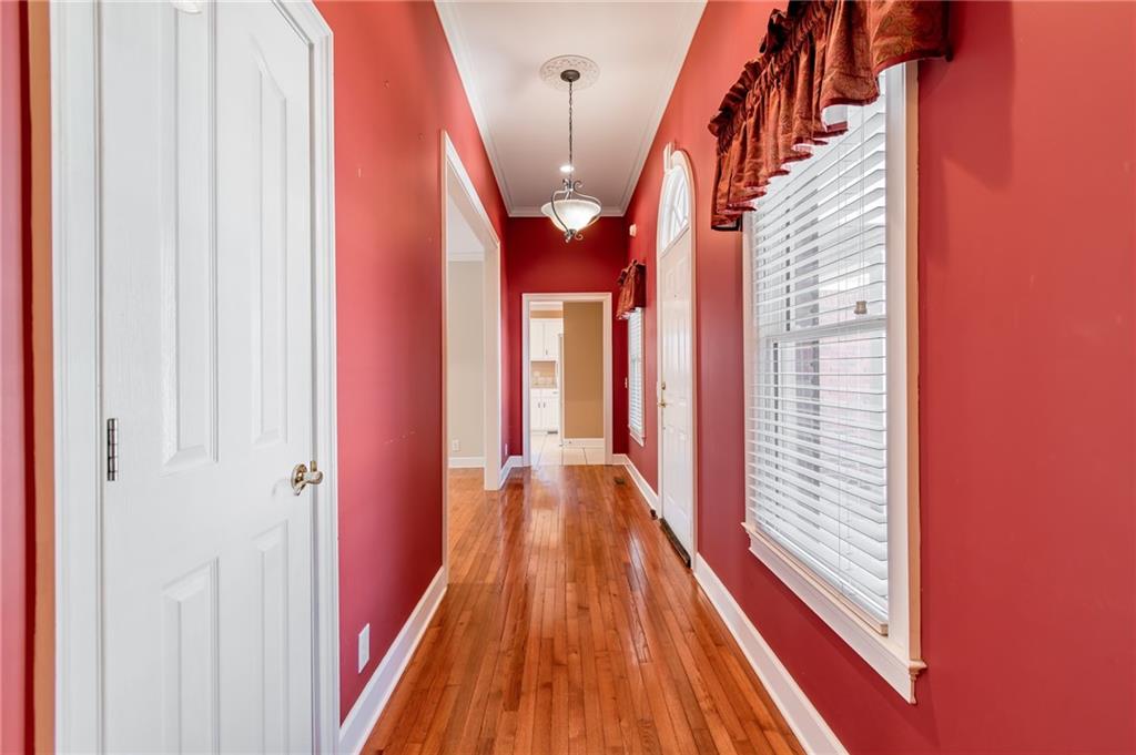 6628 Windvane Point Clermont, GA 30527 - Photo 22 of 41 a view of a hallway with wooden floor and staircase