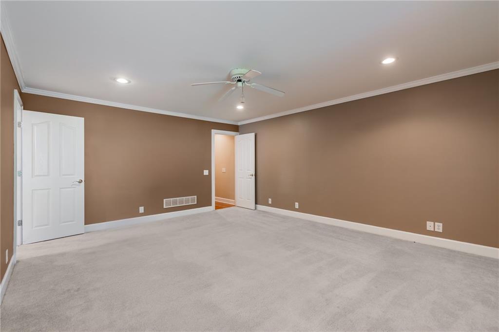 6628 Windvane Point Clermont, GA 30527 - Photo 24 of 41 a view of an empty room with a ceiling fan
