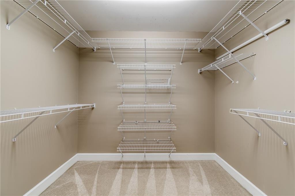6628 Windvane Point Clermont, GA 30527 - Photo 26 of 41 a view of walk in closet with empty racks