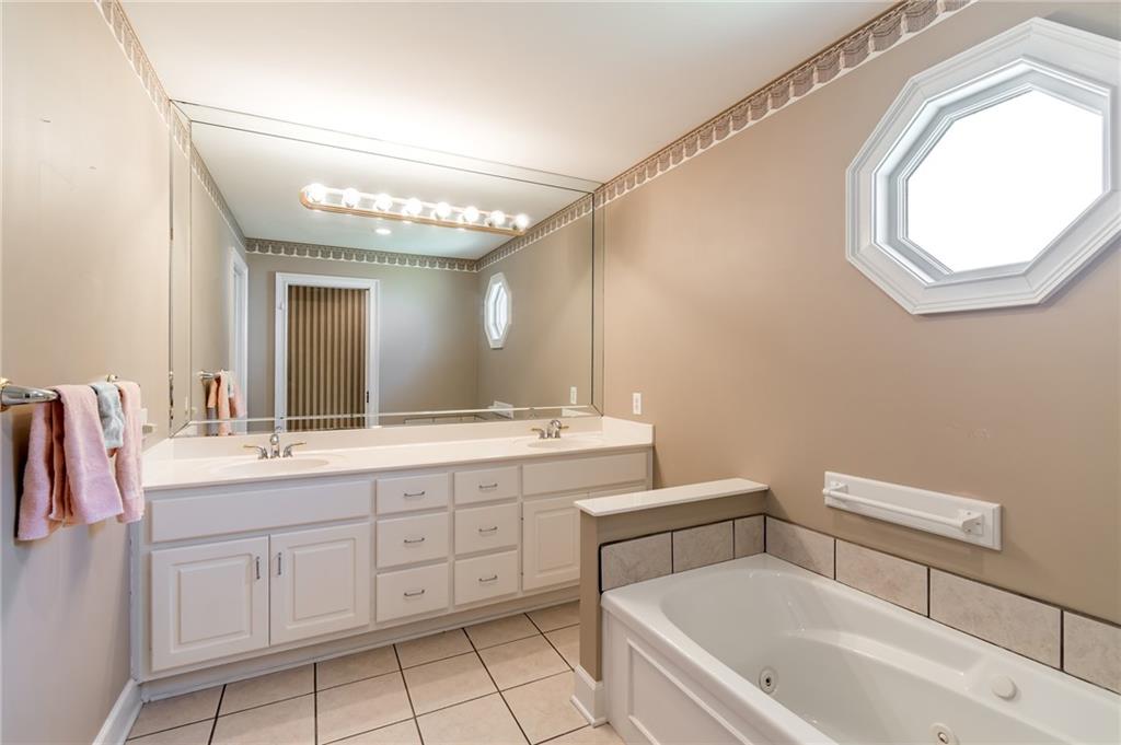 6628 Windvane Point Clermont, GA 30527 - Photo 27 of 41 a bathroom with a toilet sink and mirror