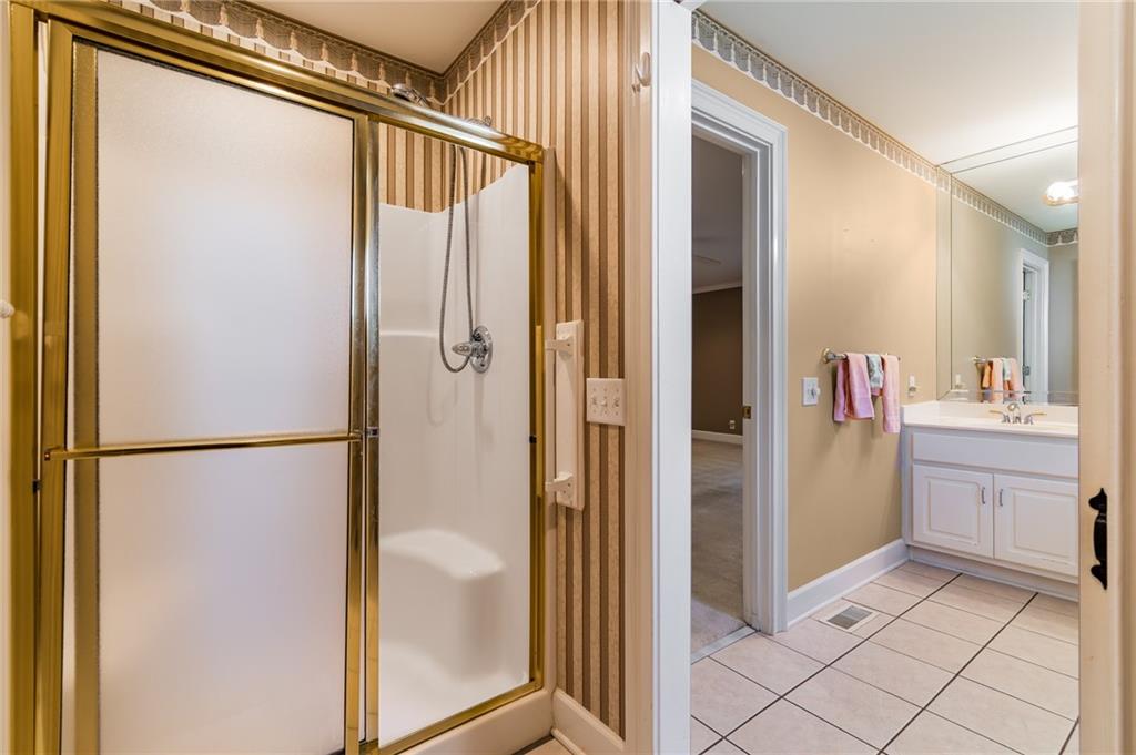 6628 Windvane Point Clermont, GA 30527 - Photo 28 of 41 a bathroom with a shower and a sink