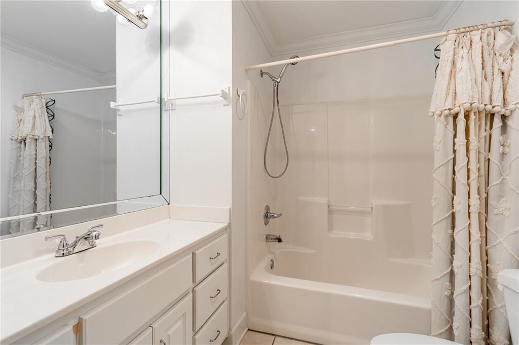 6628 Windvane Point Clermont, GA 30527 - Photo 31 of 41 a bathroom with a bath tub sink vanity and a mirror