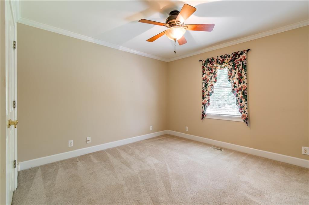 6628 Windvane Point Clermont, GA 30527 - Photo 32 of 41 an empty room with windows and fan