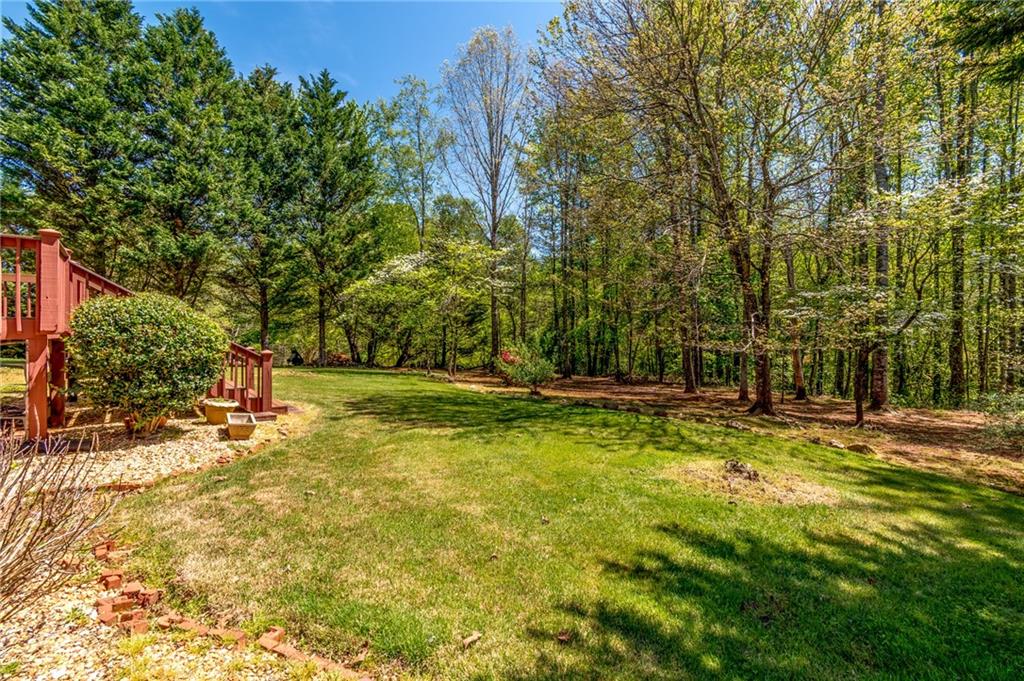 6628 Windvane Point Clermont, GA 30527 - Photo 37 of 41 a view of yard with swimming pool and trees