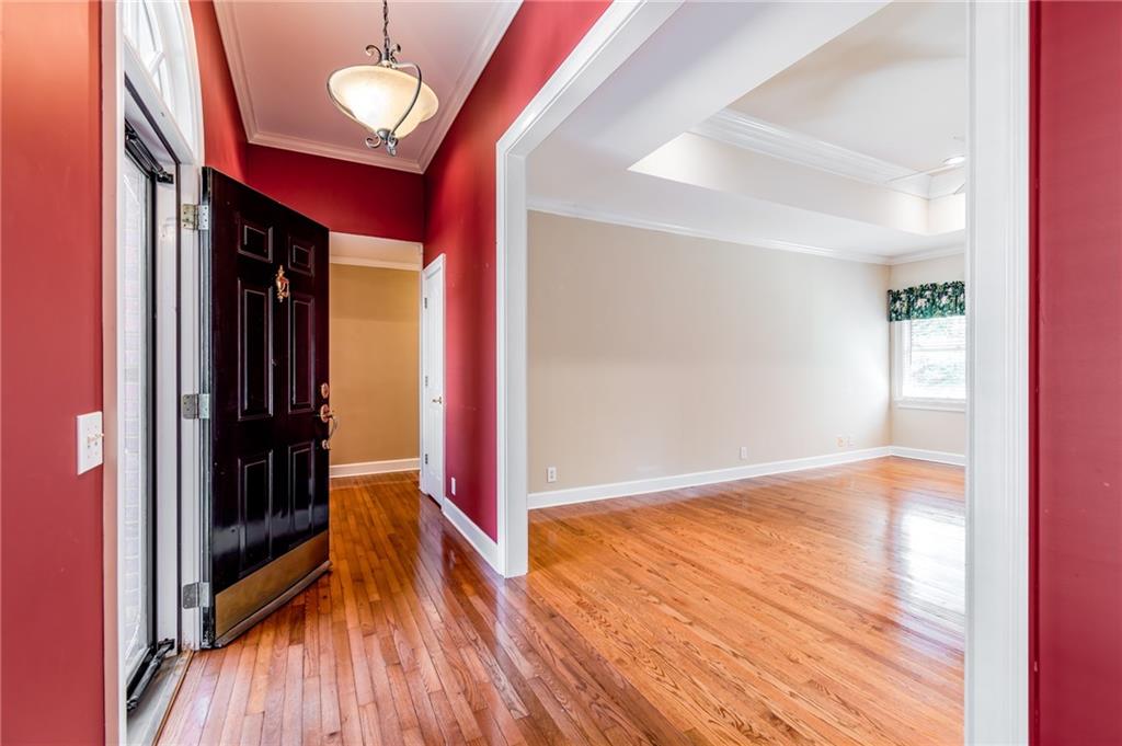 6628 Windvane Point Clermont, GA 30527 - Photo 6 of 41 a view of an empty room with wooden floor