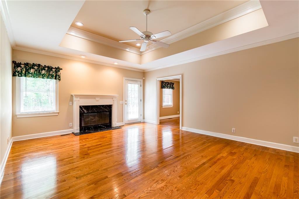 6628 Windvane Point Clermont, GA 30527 - Photo 7 of 41 a view of an empty room with window and wooden floor