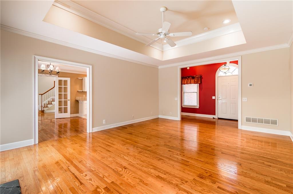 6628 Windvane Point Clermont, GA 30527 - Photo 8 of 41 a view of an empty room with window and wooden floor