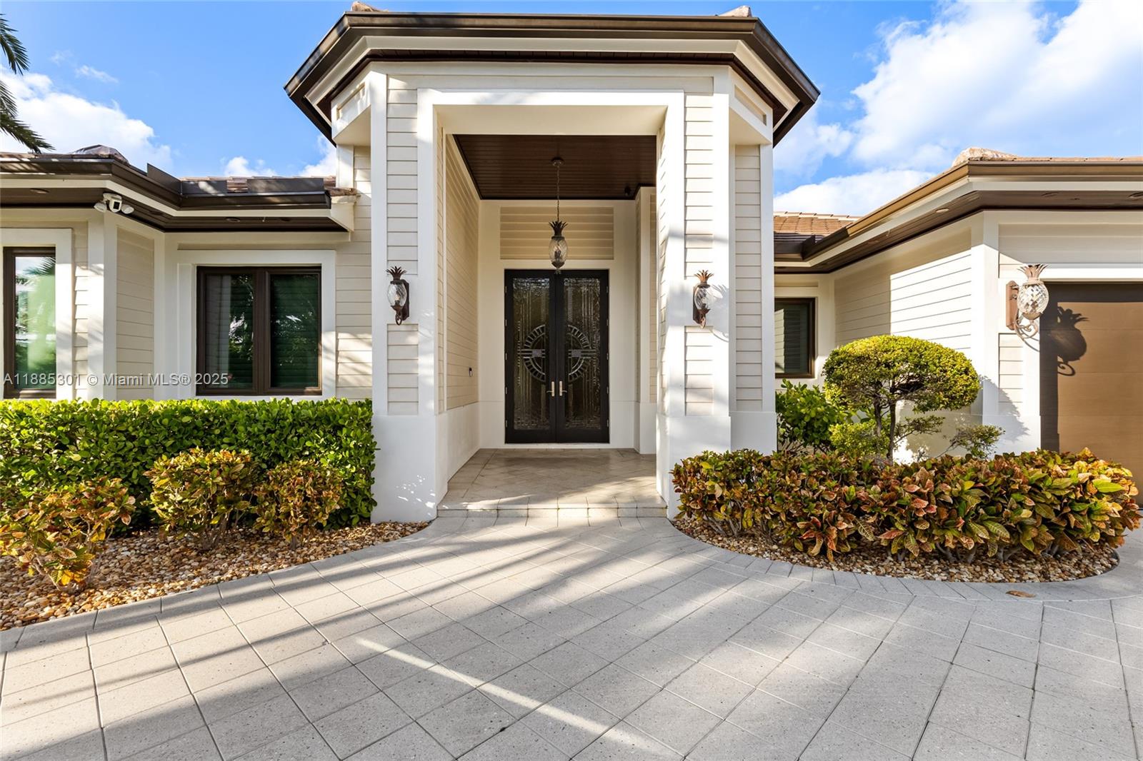 a front view of a house with lots of flowers