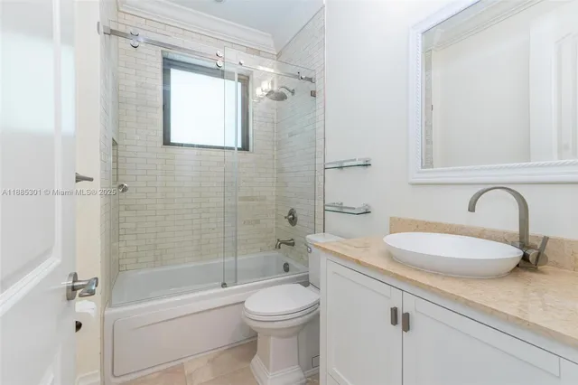 a bathroom with a granite countertop sink and a window