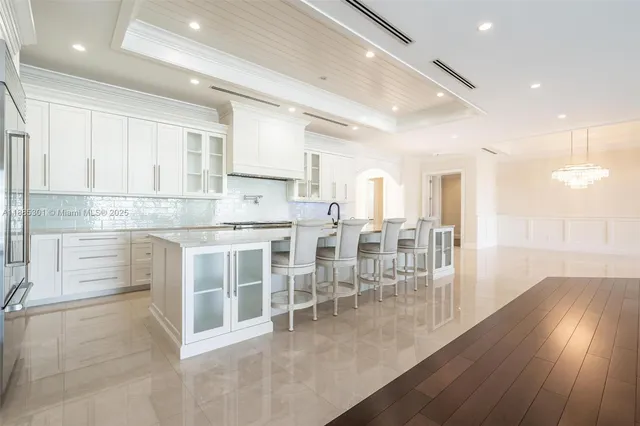 a kitchen with cabinets and chairs