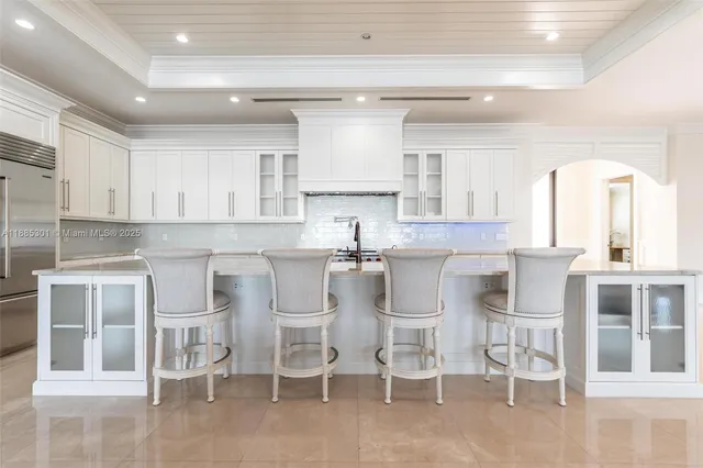 a large kitchen with stainless steel appliances granite countertop a lot of counter space and wooden floors