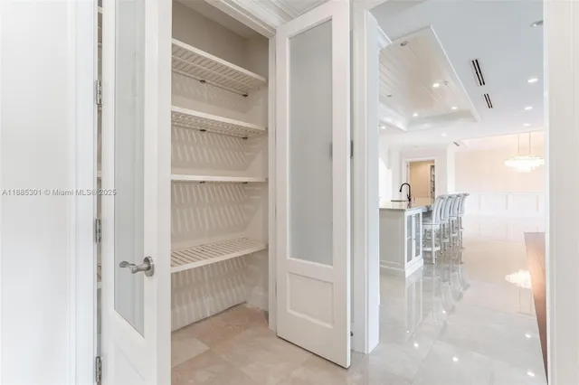 a living room with furniture and a view of kitchen