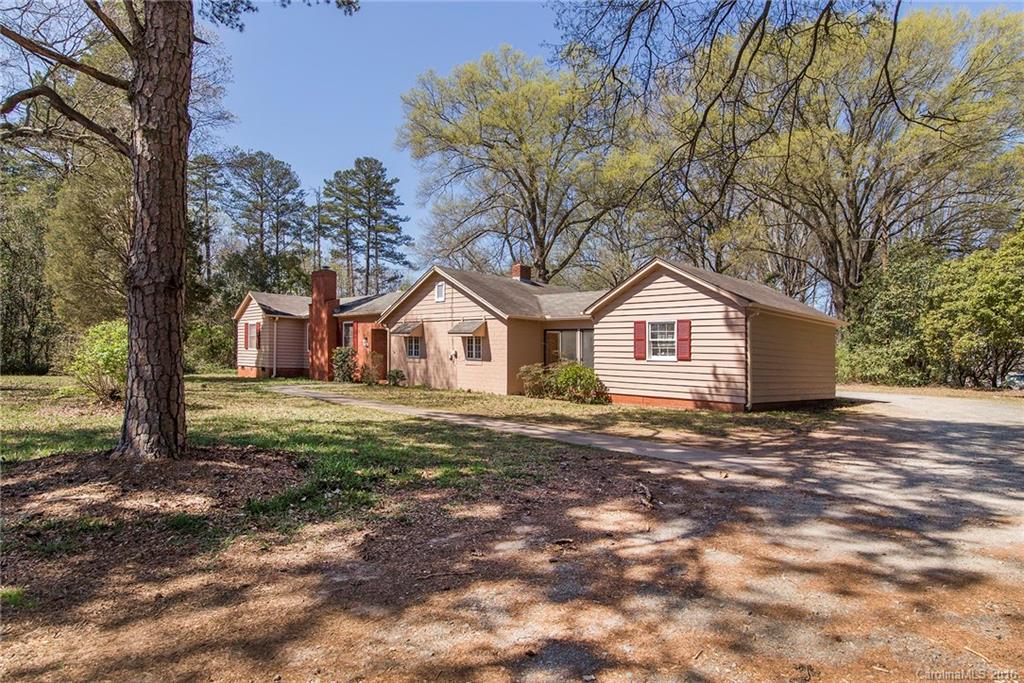 5132 Tuckaseegee Road Charlotte, NC 28208 - Photo 2 of 15 a front view of a house with a yard and garage