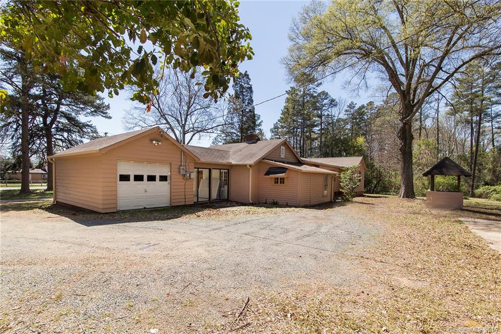 5132 Tuckaseegee Road Charlotte, NC 28208 - Photo 3 of 15 a front view of a house with a yard and tree