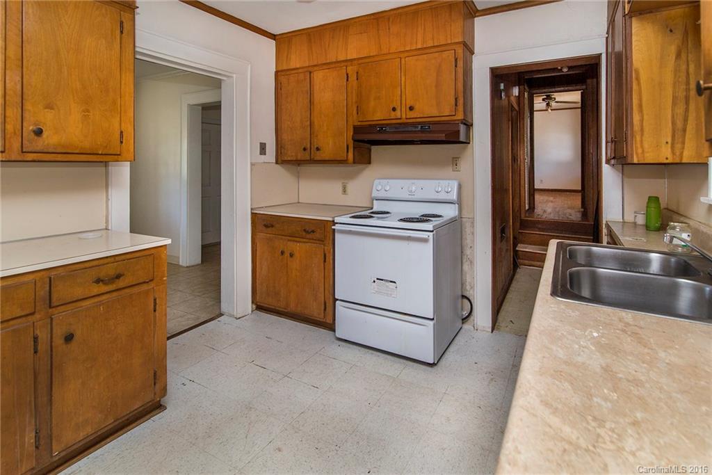 5132 Tuckaseegee Road Charlotte, NC 28208 - Photo 4 of 15 a kitchen with stainless steel appliances granite countertop a stove a sink and a refrigerator with cabinets
