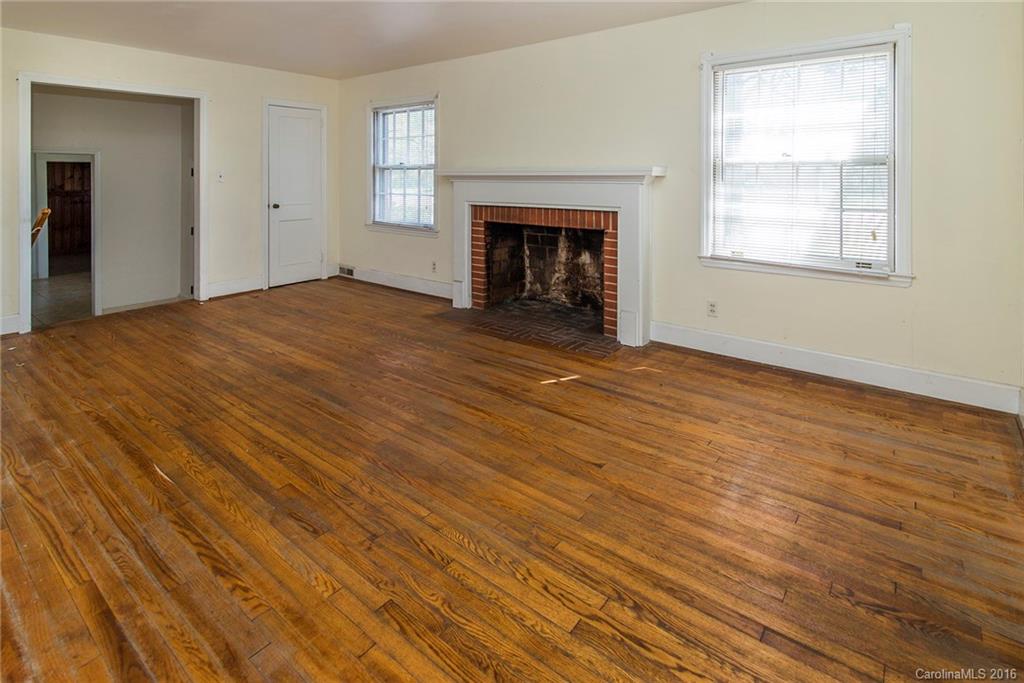5132 Tuckaseegee Road Charlotte, NC 28208 - Photo 5 of 15 an empty room with windows and fireplace