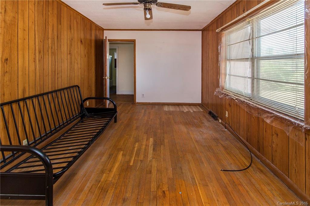 5132 Tuckaseegee Road Charlotte, NC 28208 - Photo 8 of 15 a view of a room with wooden floor and iron stairs