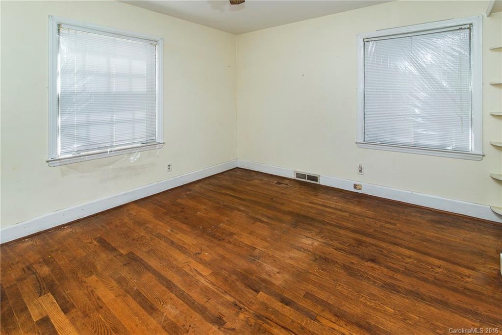 5132 Tuckaseegee Road Charlotte, NC 28208 - Photo 10 of 15 an empty room with wooden floor and windows