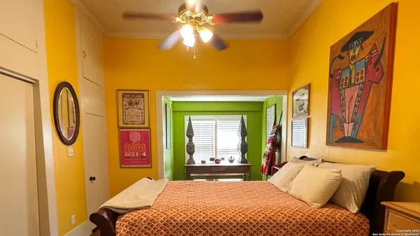 a bedroom with a bed and a chandelier