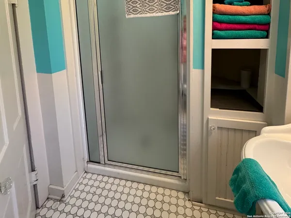 a bathroom with a toilet and a shower
