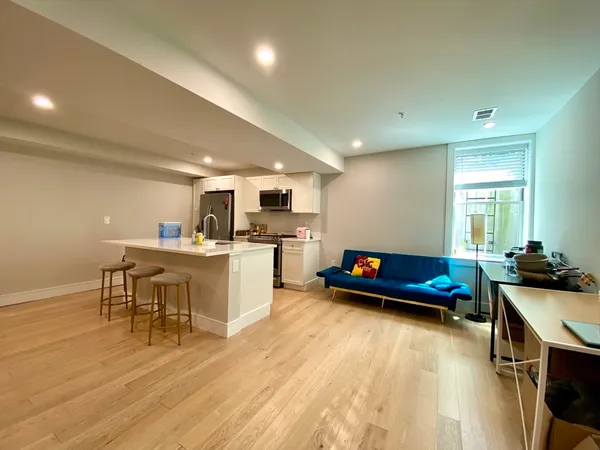 a living room with furniture and kitchen view