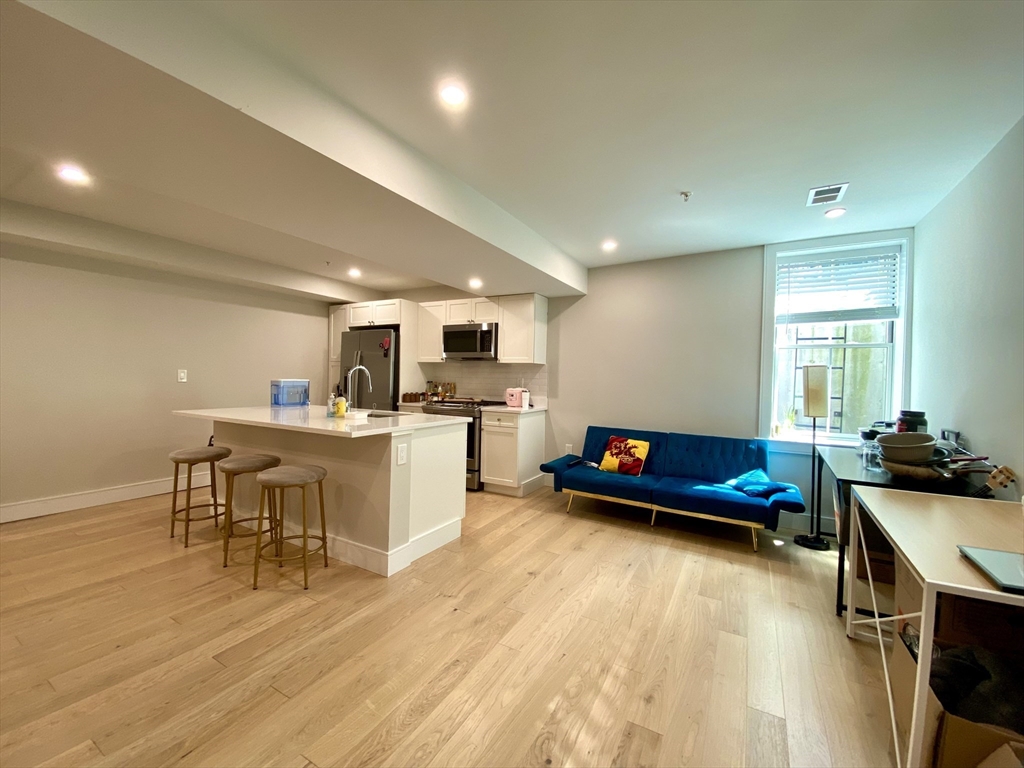 13 Greylock Road, Unit 2 Boston, MA 02134 - Photo 2 of 9 a living room with furniture and kitchen view
