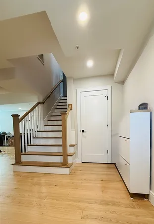 a view of a room with wooden floor and stairs