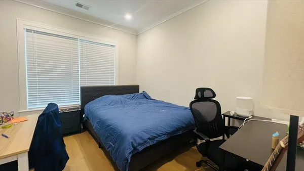 a bedroom with a bed and a window