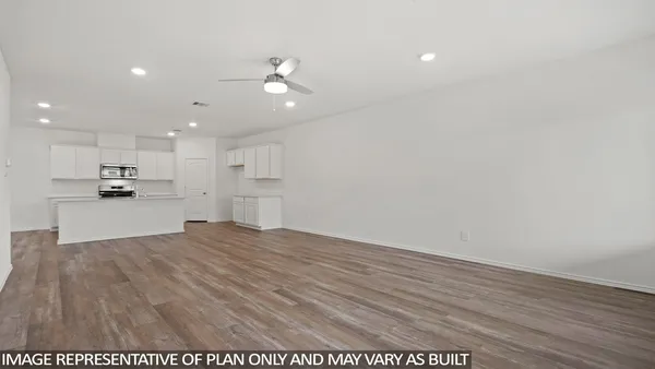 a view of kitchen with kitchen island wooden floor center island and appliances