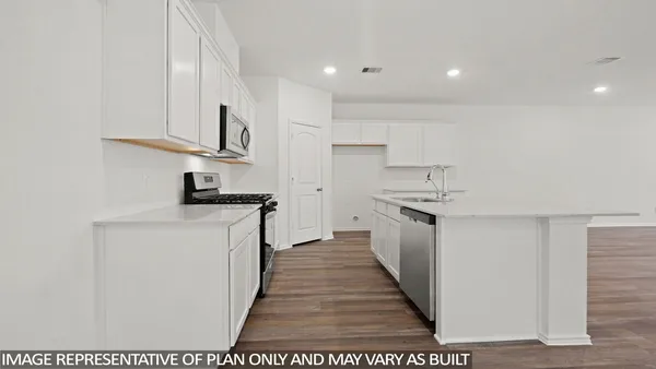 a kitchen with cabinets and white stainless steel appliances