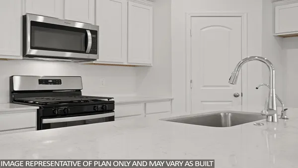 a kitchen with stainless steel appliances granite countertop a sink a stove a microwave and cabinets