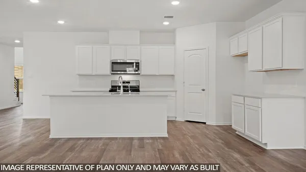 a view of kitchen with wooden floor and electronic appliances
