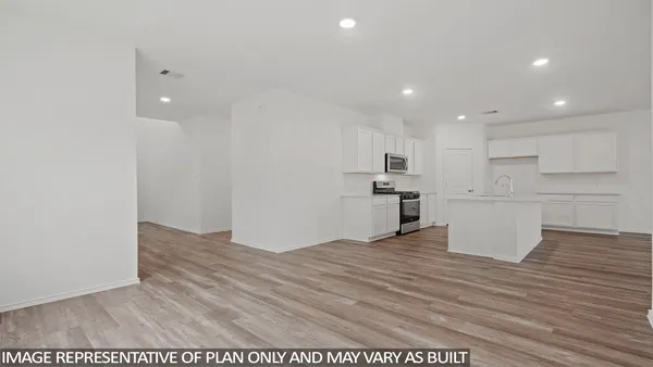 a view of kitchen with kitchen island stainless steel appliances cabinets and wooden floor