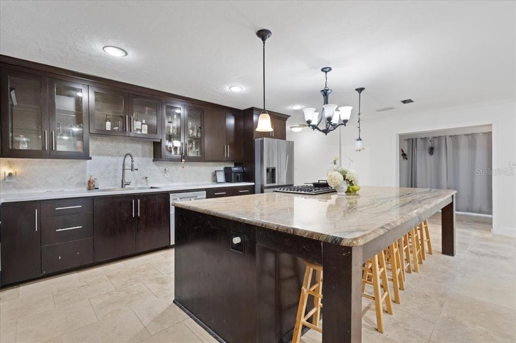 5609 Northwest 53 Court Gainesville, FL 32653 - Photo 14 of 49 a kitchen with kitchen island a sink counter top space and cabinets