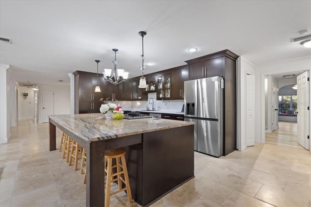 5609 Northwest 53 Court Gainesville, FL 32653 - Photo 15 of 49 a kitchen with stainless steel appliances granite countertop wooden cabinets a refrigerator and a stove