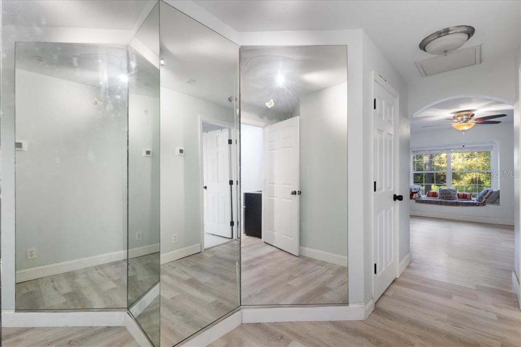 5609 Northwest 53 Court Gainesville, FL 32653 - Photo 19 of 49 a view of a hallway with wooden floor and a bathroom