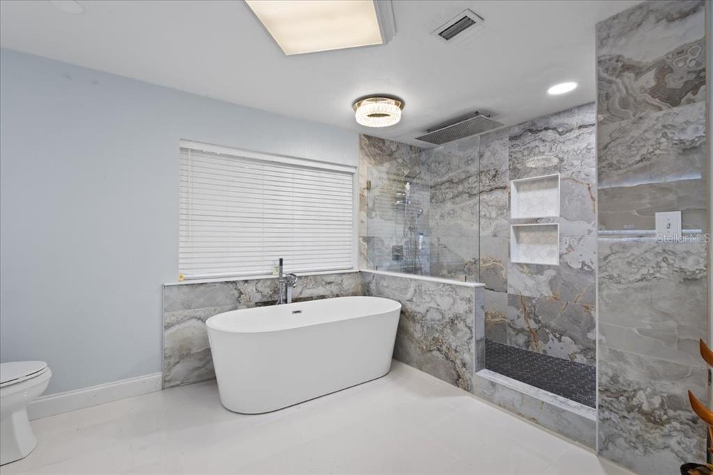 5609 Northwest 53 Court Gainesville, FL 32653 - Photo 23 of 49 a white bath tub sitting next to a white toilet