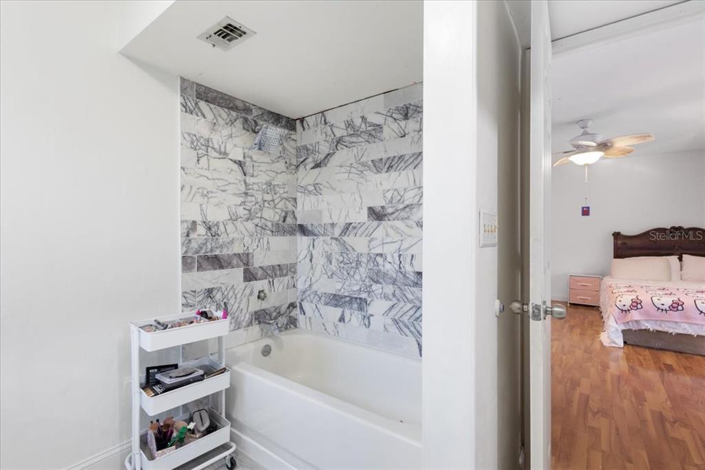 5609 Northwest 53 Court Gainesville, FL 32653 - Photo 27 of 49 a bathroom with a bathtub and shower