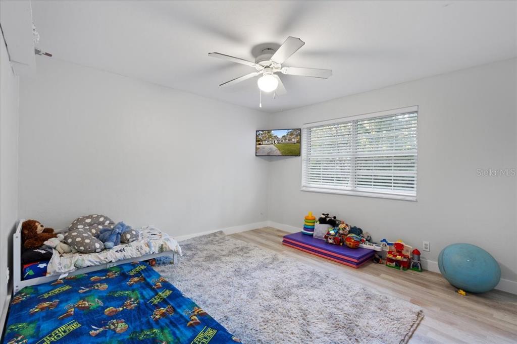 5609 Northwest 53 Court Gainesville, FL 32653 - Photo 28 of 49 a bedroom with a bed and a dresser in it