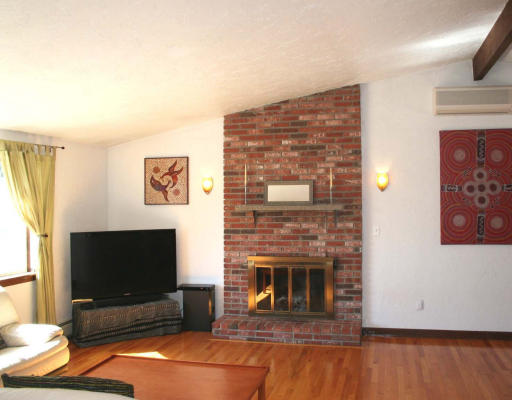53 Upland Road West Arlington, MA 02474 - Photo 2 of 11 a living room with fireplace and a flat screen tv