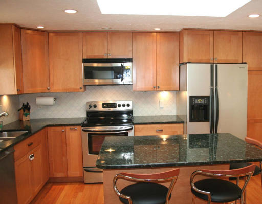 53 Upland Road West Arlington, MA 02474 - Photo 3 of 11 a kitchen with stainless steel appliances granite countertop a sink stove and refrigerator