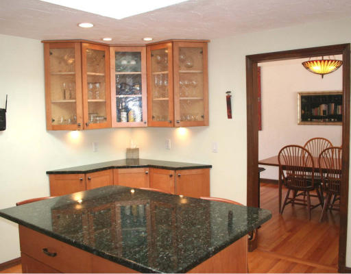53 Upland Road West Arlington, MA 02474 - Photo 4 of 11 a kitchen with a table chairs and a wooden floor