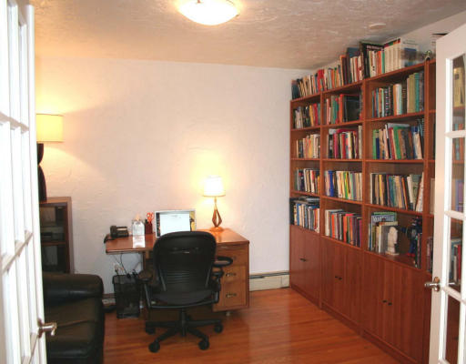 53 Upland Road West Arlington, MA 02474 - Photo 10 of 11 a view of a workspace with furniture and a book shelf