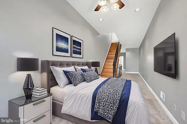 a bed room with a bed window and a flat screen tv