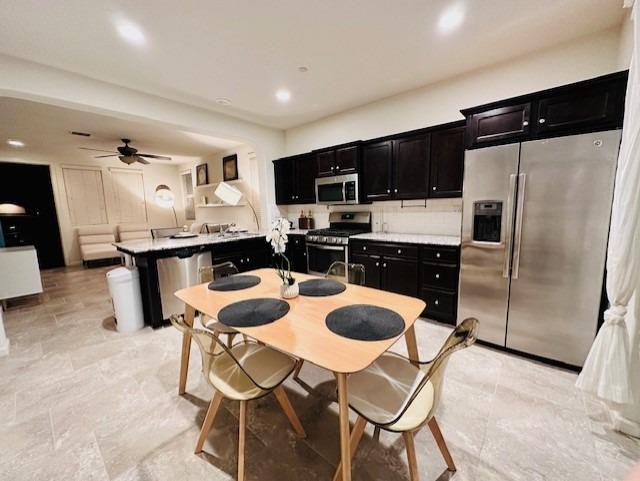 3762 Amity Lane Clovis, CA 93619 - Photo 6 of 15 a kitchen with stainless steel appliances kitchen island granite countertop a sink and cabinets