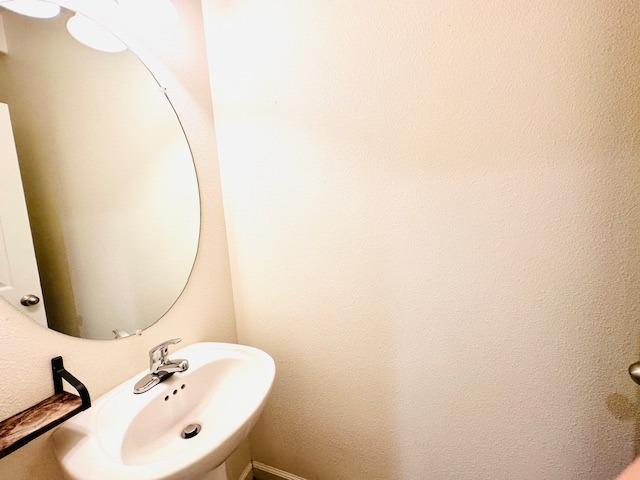 3762 Amity Lane Clovis, CA 93619 - Photo 8 of 15 a bathroom with a sink and a mirror