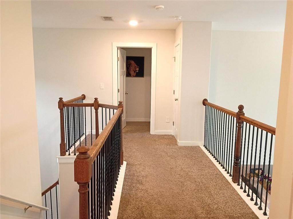 807 Ridgeview Court Hampton, GA 30228 - Photo 36 of 69 a view of a hallway with wooden floor and staircase