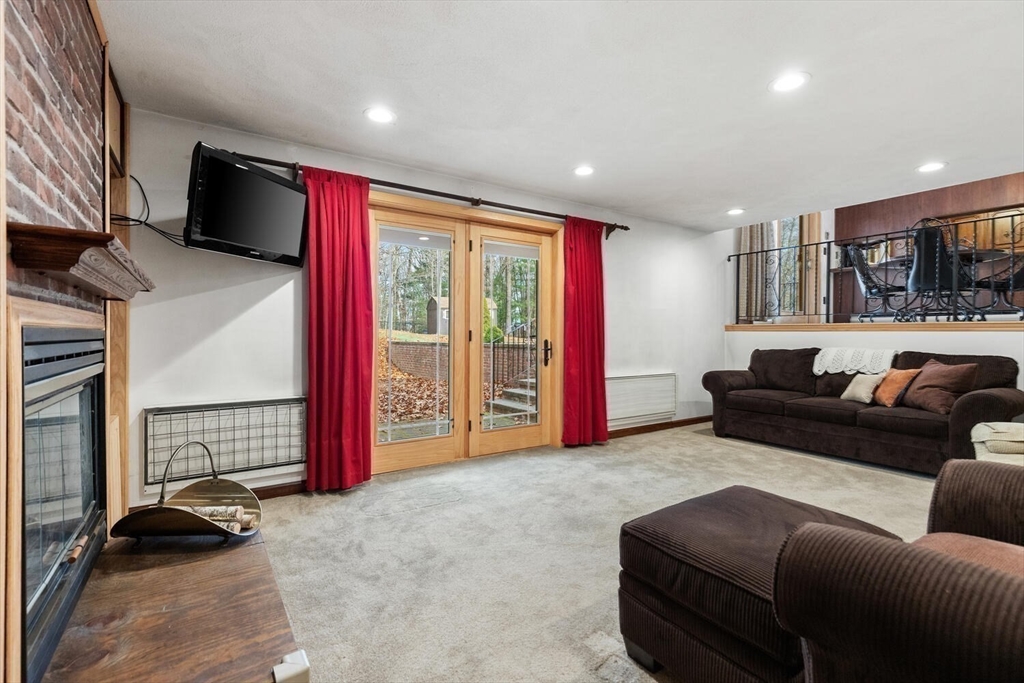13 Dix Road Ipswich, MA 01938 - Photo 14 of 30 a living room with furniture a flat screen tv and a refrigerator