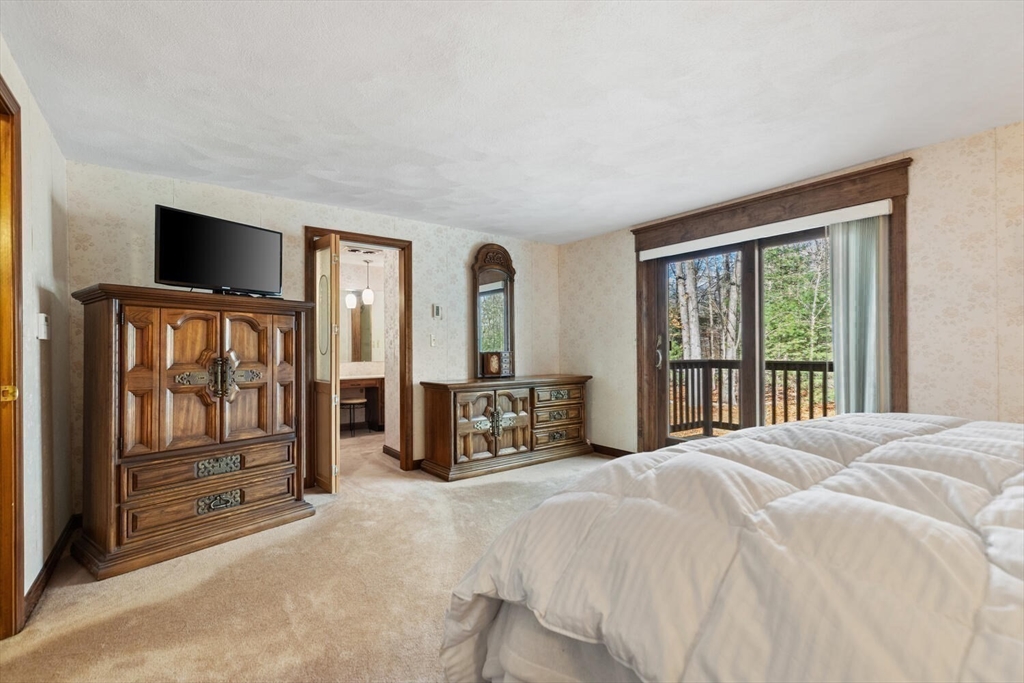 13 Dix Road Ipswich, MA 01938 - Photo 21 of 30 a bedroom with a balcony a bed and a dresser next to a window