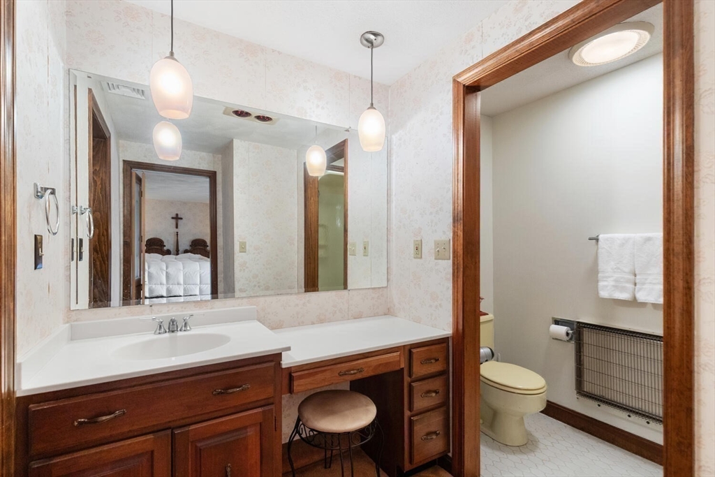 13 Dix Road Ipswich, MA 01938 - Photo 22 of 30 a bathroom with a toilet a sink a mirror and vanity
